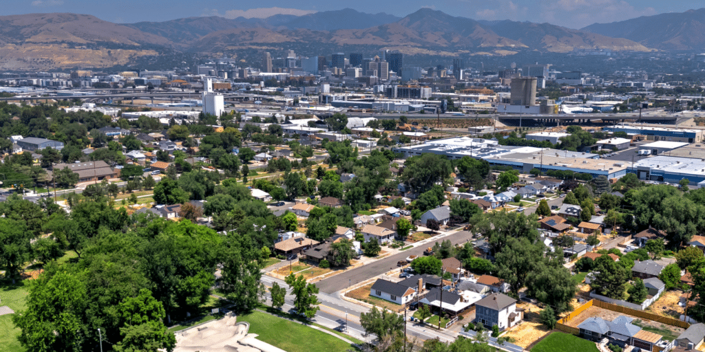 Aerial view of the Glendale neighborhood in Salt Lake City Utah, downtown high-rises and mountains in the background